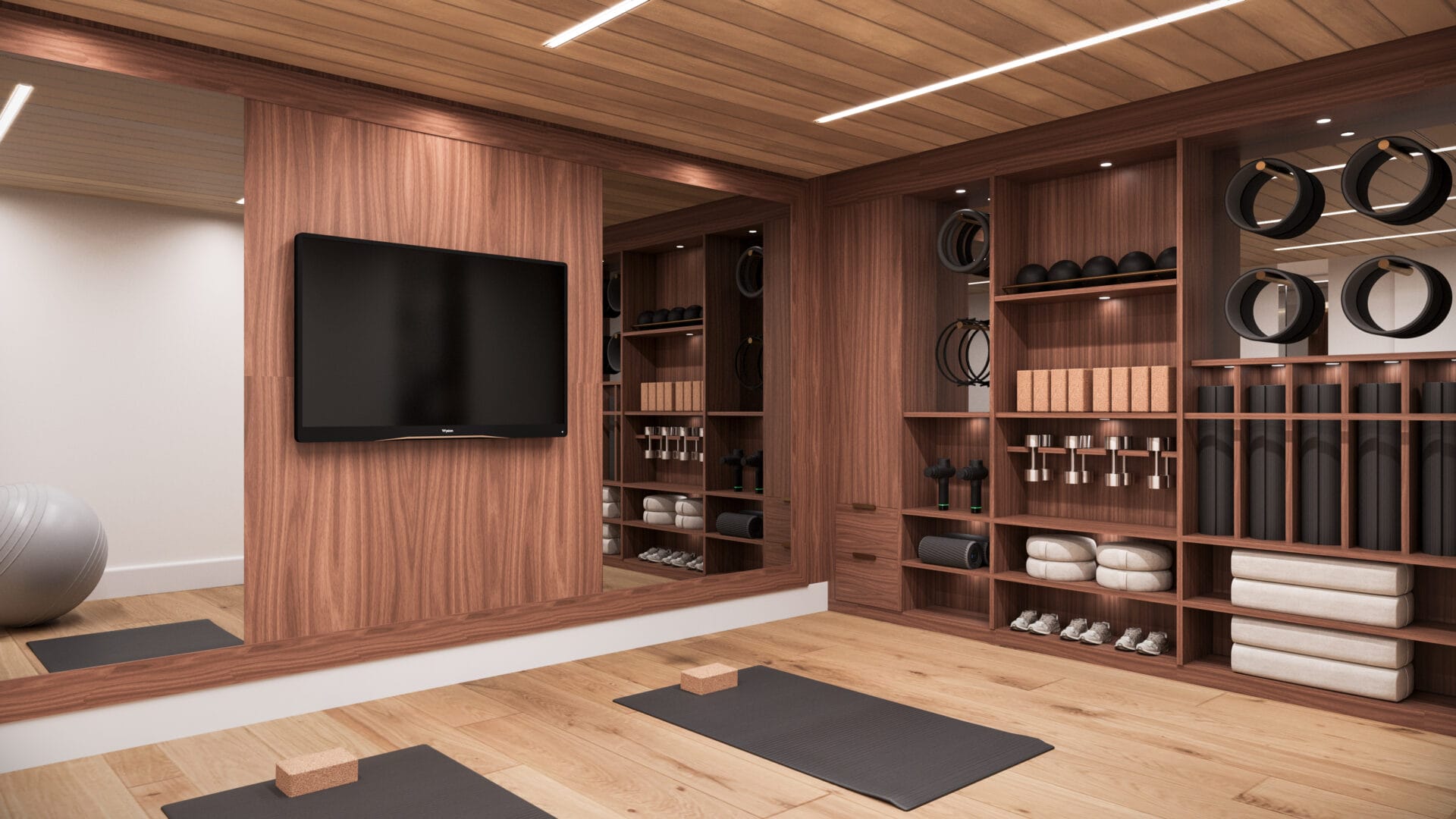 A room with wooden walls and floors, yoga mats on the floor.